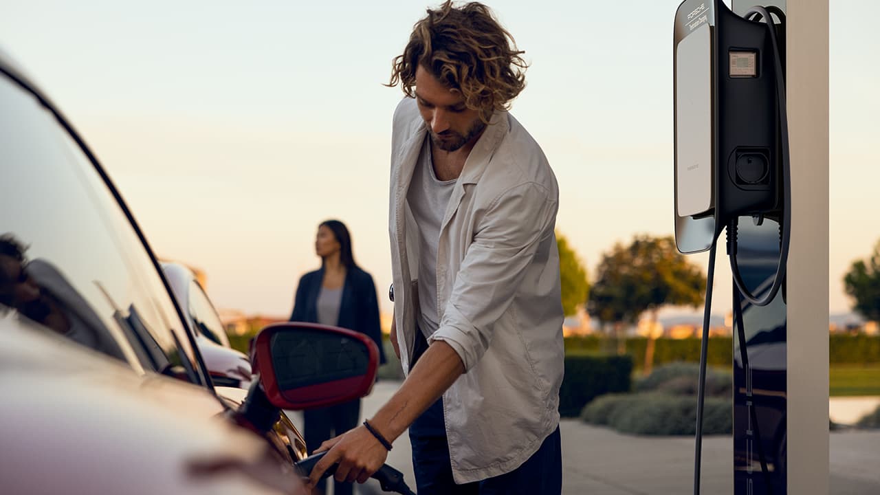 Man charging a Porsche